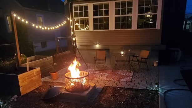 A backyard with a fire pit, outdoor furniture, and string lights. - Short Walk to Churchill Downs! (Louisville)