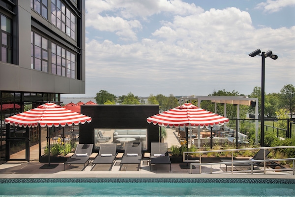 Seasonal outdoor pool, open 10:00 AM to 8:00 PM, pool umbrellas