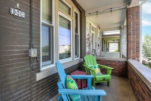 Relax on the porch with two Adirondack chairs and a small table.