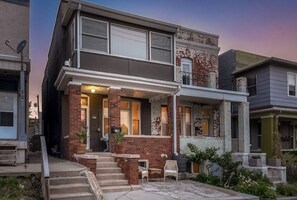 Stroll up to this charming two-story home with a cozy front porch and seating area.