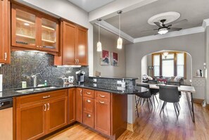 Enjoy cooking in this well-equipped kitchen with a central island, sink, dishwasher, and oven.