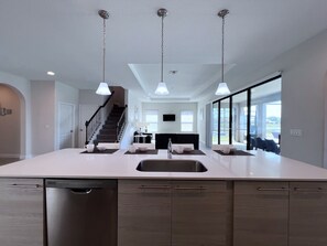 Prepare meals in the kitchen with a spacious island, sink, and ample counter space.