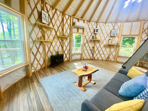 Elevated eclectic yurt with wrap-around porch, hot tub, and mountain view!