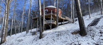 Elevated eclectic yurt with wrap-around porch, hot tub, and mountain view!