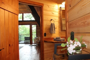 A wooden cabin interior with a wooden bench, a sink, and a window overlooking greenery. - Private mountain cabin surrounded by Nat'l Forest! Visit wineries, hike the AT! (Cleveland)