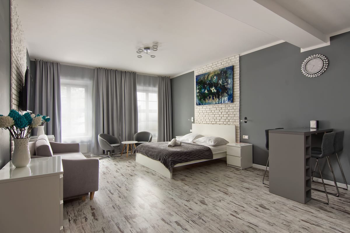 Ein modernes Schlafzimmer mit Bett, Nachttischen, Schreibtisch und Stuhl.
