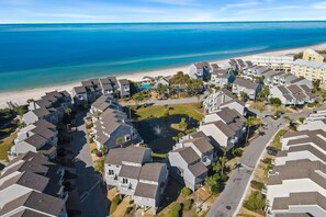 A coastal residential area with multi-story buildings, a beach, and a small water body. - Cozy Dog-Friendly Cottage · Steps to Gulf Beach (Port St. Joe)