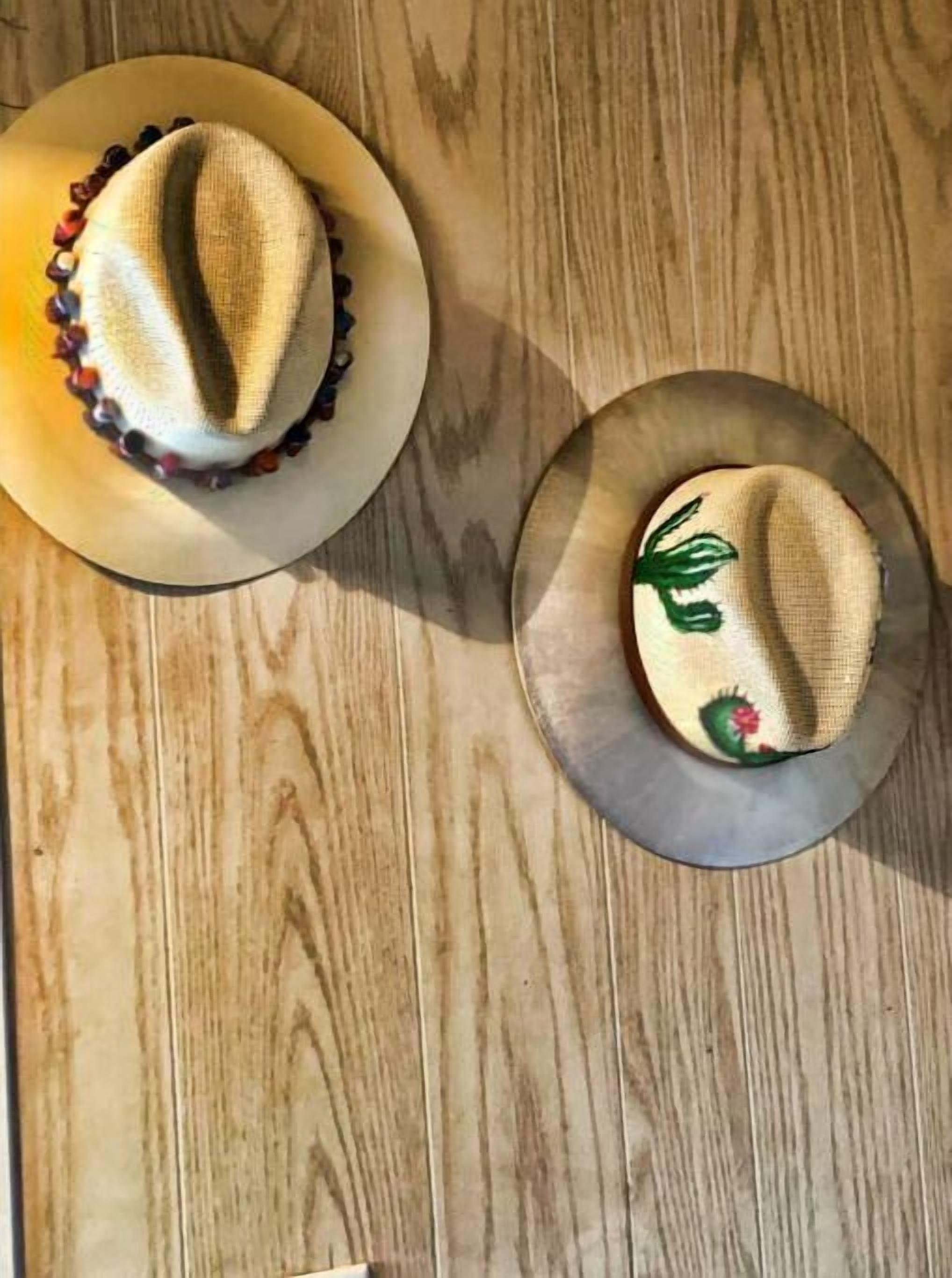 Two hats on a wooden surface.