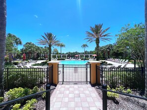 A pool area with lounge chairs and a gated entrance. - LAKEVIEW from Your Private Pool! Relax & Create Memories! Resort Near Disney! (Davenport)
