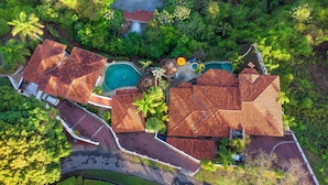 An aerial view of a resort with multiple buildings, a swimming pool, and lush greenery. - Papagayo Ocean View Luxury Villa (Carrillo Guanacaste)