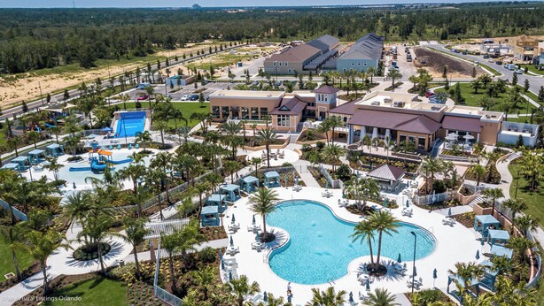 A resort with a large pool, multiple buildings, and a water park.