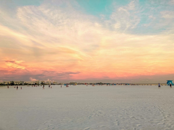 A beach with a clear sky and buildings in the background. - Get here fast, then take it slow... Right — ON — Siesta Beach at Condo Kokomo! (Siesta Key)