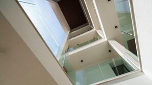 Un bâtiment moderne doté d’une façade en verre et de nombreux balcons.