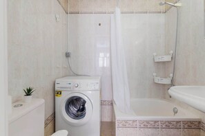 Bathtub, hair dryer, towels