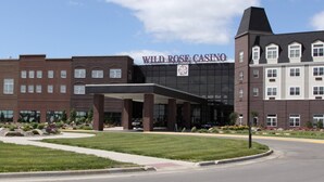 A multi-story building with a prominent casino sign, featuring a large entrance and a covered area.