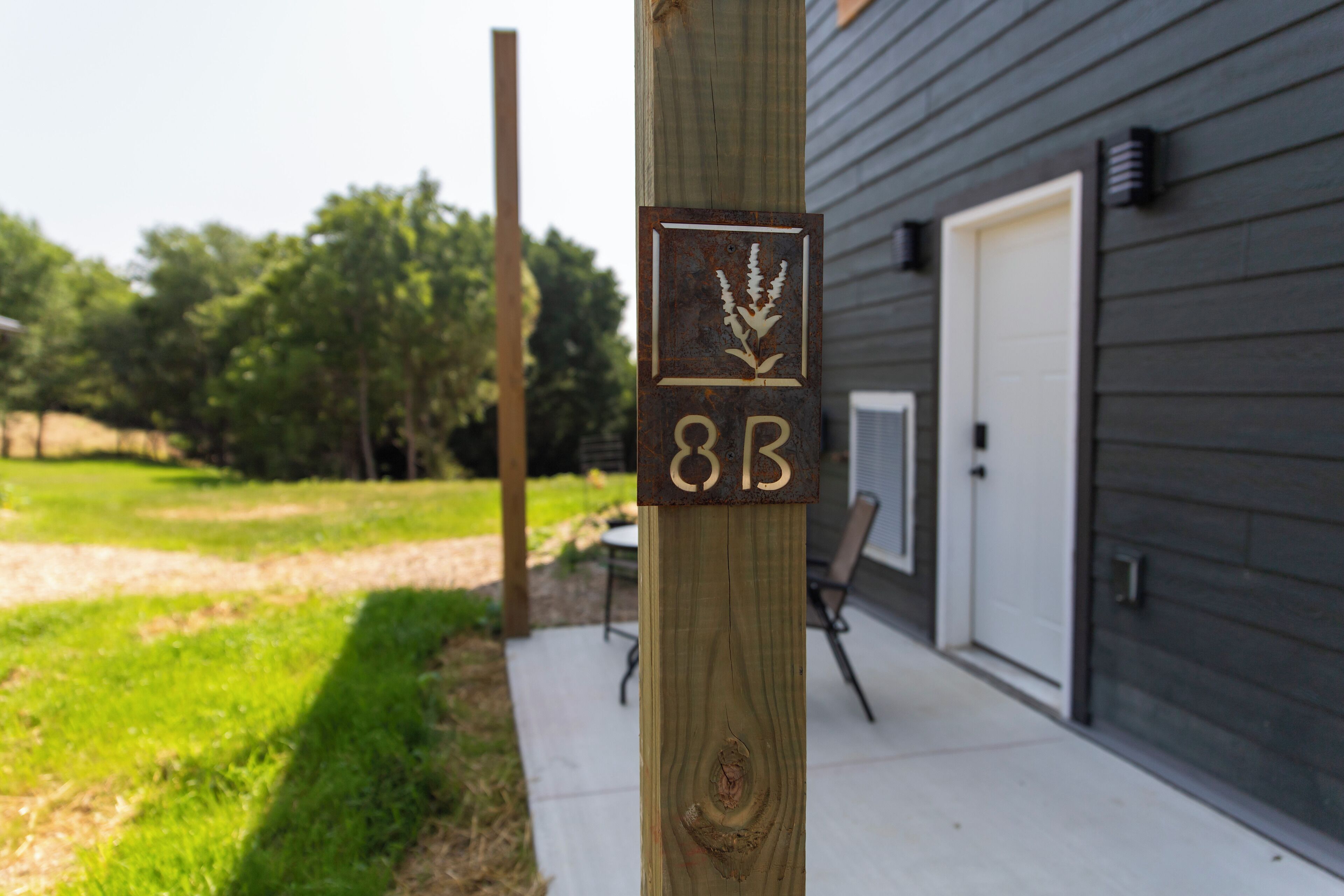 A wooden post with a plaque displaying the number "88" and a logo.