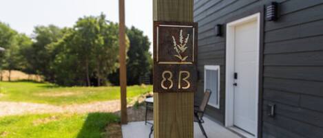 A wooden post with a plaque displaying the number "88" and a logo.