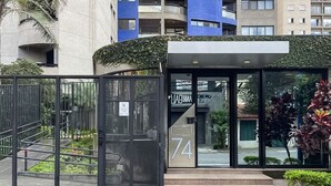 A modern building entrance with a glass door marked "74".