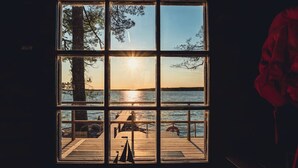 A room with a large window overlooking a body of water and a dock. - State of the Art Coastal Villa (Salo)