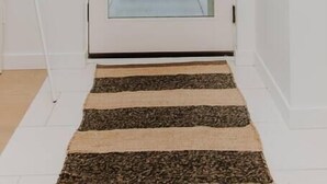 A white door with a glass panel, leading to an outdoor view of trees and a mountain. - Red Mtn Private Mountain Escape for Active Couples (Rossland)