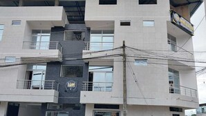 A multi-story building with a modern design, featuring balconies and large windows. - Hospedaje Moralillos (Yurimaguas)
