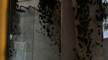 Ocre | Bathroom | Shower, rainfall showerhead, hair dryer, towels