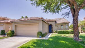 A residential house with a garage, a front yard with a tree, and a well-maintained lawn. - 2 Mi to Coachella: Indio Home w/ Outdoor Oasis (Indio)