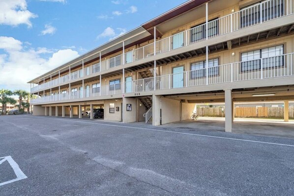 A multi-story parking garage with a flat roof and a single staircase leading to the upper levels.