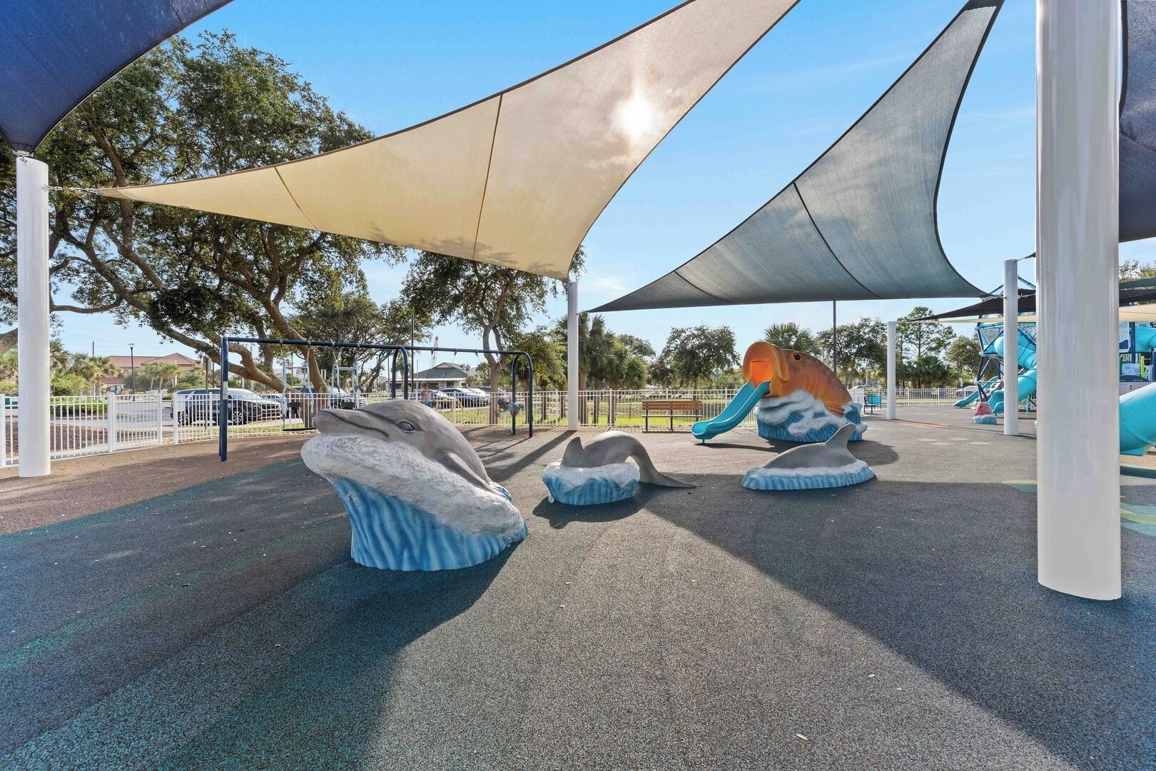 A playground with a slide and whale-shaped play structures.