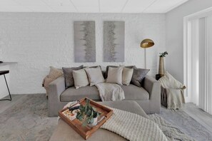Relax in this stylish living room with a sofa, coffee table, and floor lamp.