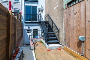 Stroll through the charming alleyway to the entrance of this residential building.