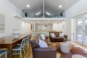 Enjoy a spacious living area with a mezzanine level, dining space, and kitchen, perfect for relaxing and entertaining.