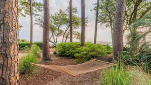 A hammock between trees in a natural setting with a view of the sea. - Coastal Villa by the Beach (Hilton Head Island)