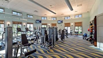 A gym with treadmills, weight machines, and exercise balls.