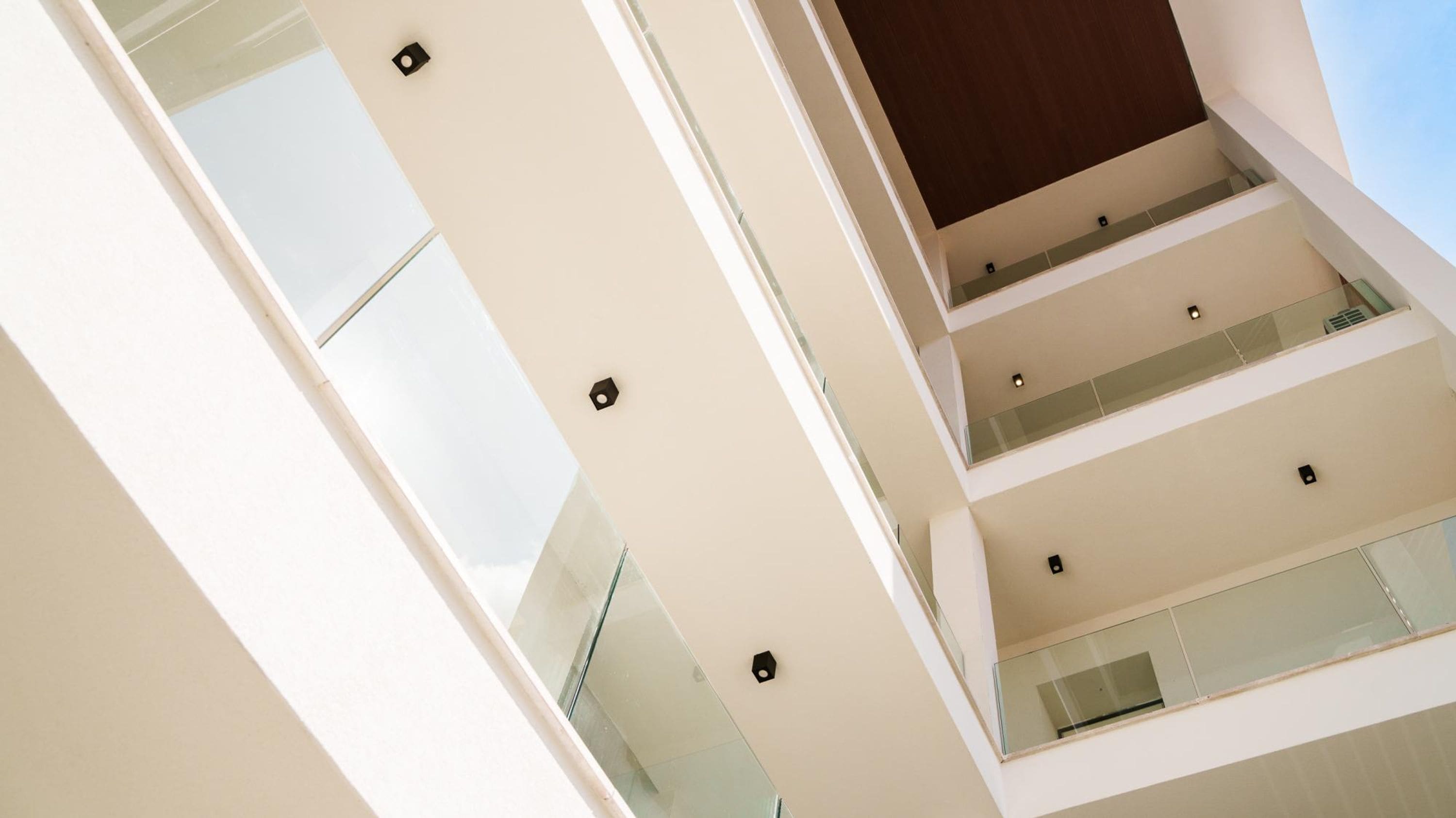 A multi-level building with glass railings and a modern architectural design.