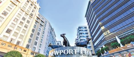 Un edificio con el letrero 'NEWPORT CITY' y una escultura de dos animales.