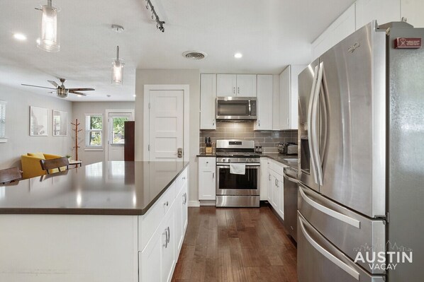 Enjoy cooking in this well-lit kitchen with a central island and modern appliances.
