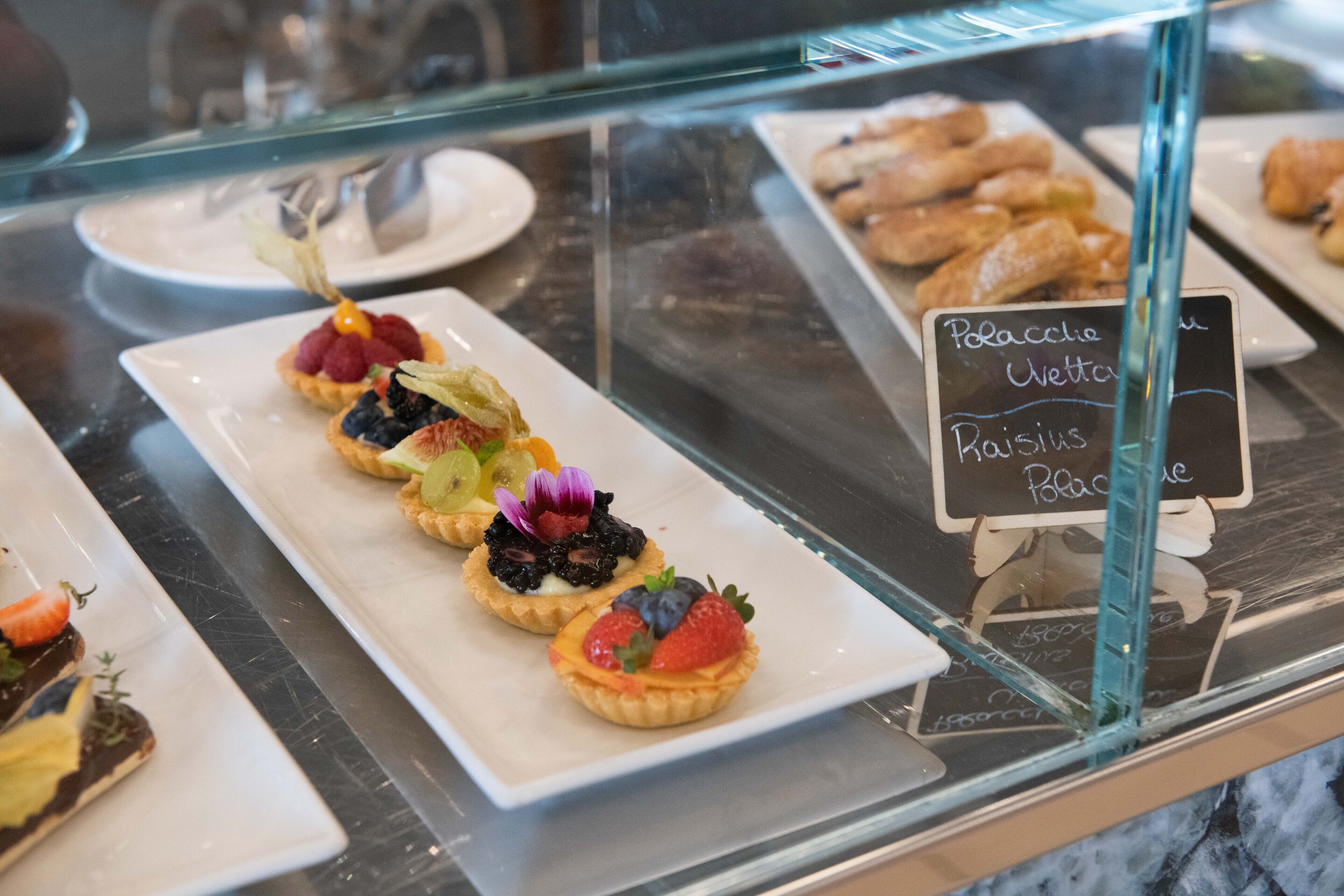 A dessert display with various pastries and tarts.