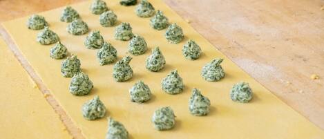 A flatbread with green herb balls on a wooden surface.