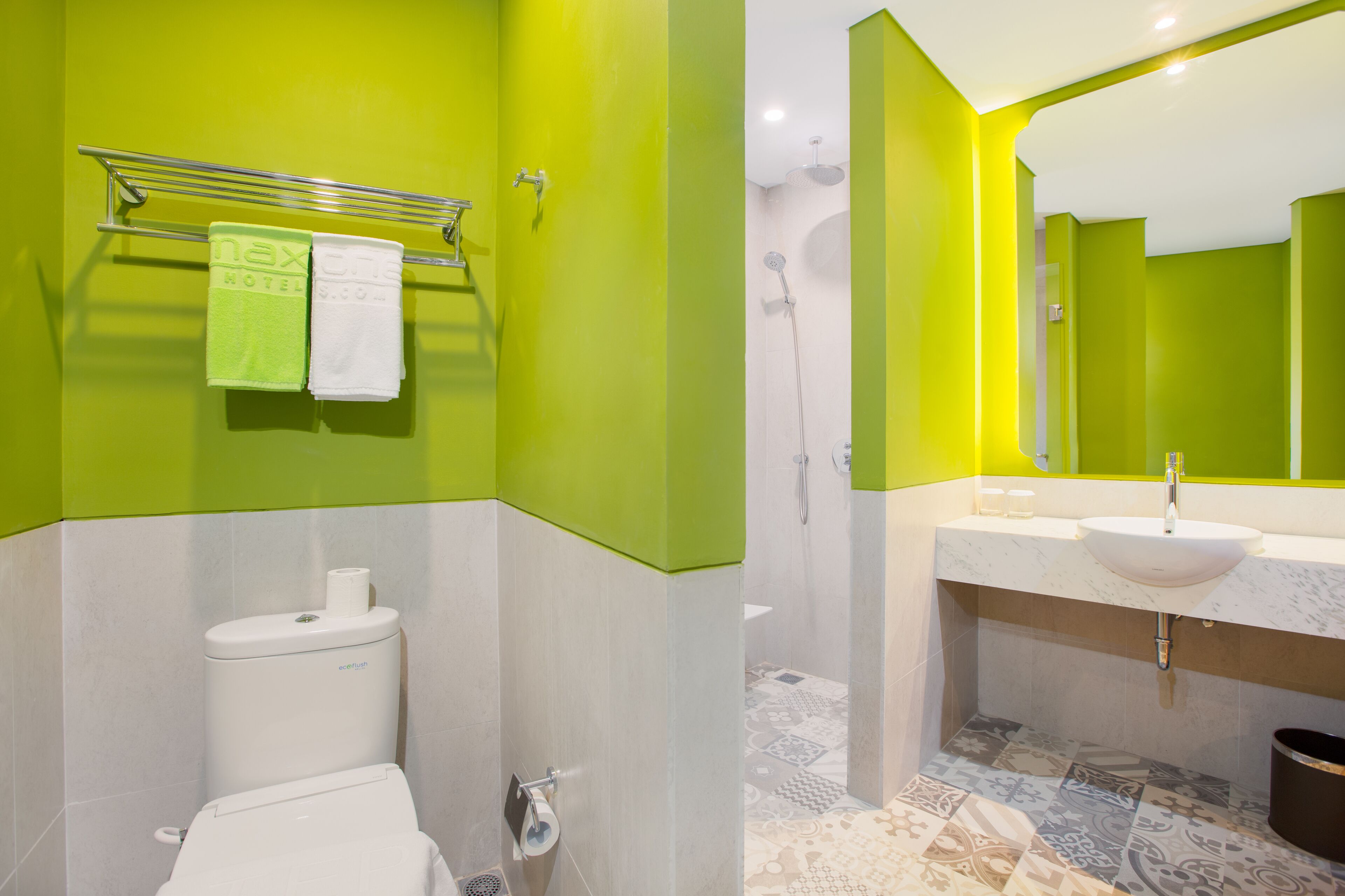 A bathroom with a toilet, a sink, and a shower.