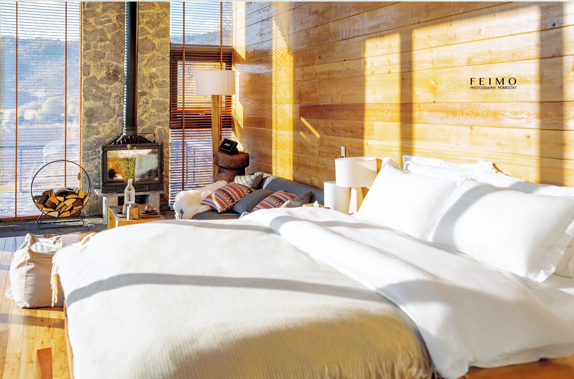Un dormitorio acogedor con una cama grande, una chimenea y vistas al exterior.