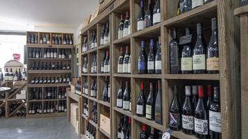 A wine shop with wooden shelves stocked with various wine bottles.