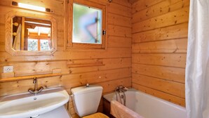 A wooden cabin bathroom with a sink, toilet, and bathtub. - Chalet "Maison De Bois Finlandaise" with 2 Private Terraces & Balcony (Bolquère)