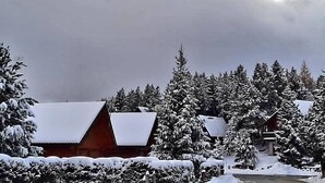 A snow-covered lodge with multiple cabins, surrounded by dense evergreen trees. - Chalet "Maison De Bois Finlandaise" with 2 Private Terraces & Balcony (Bolquère)