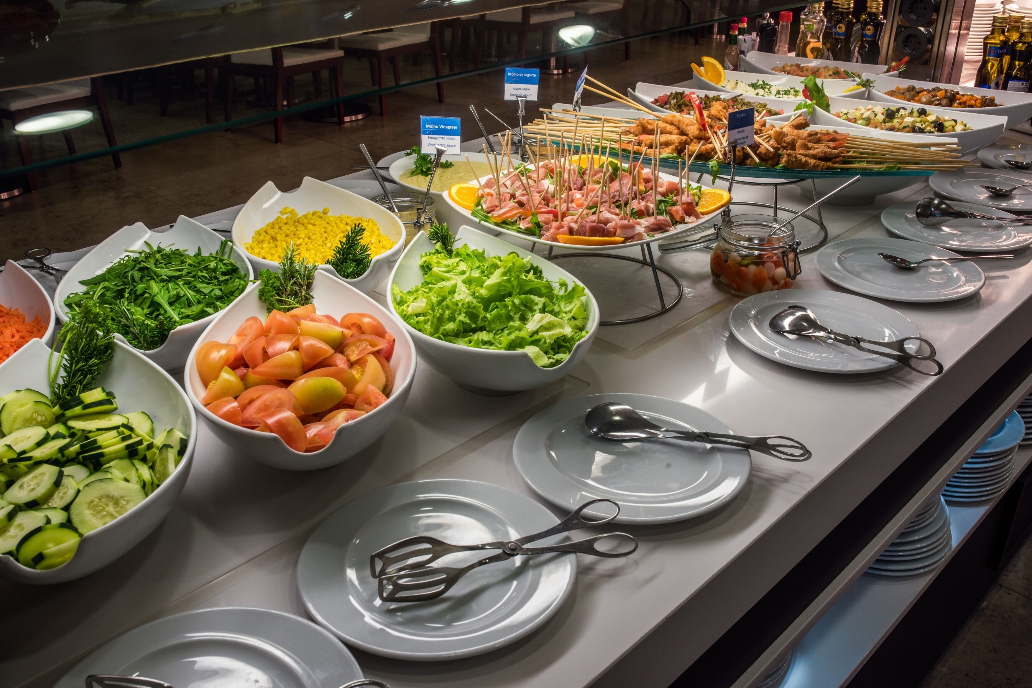 A buffet with various food items and utensils.