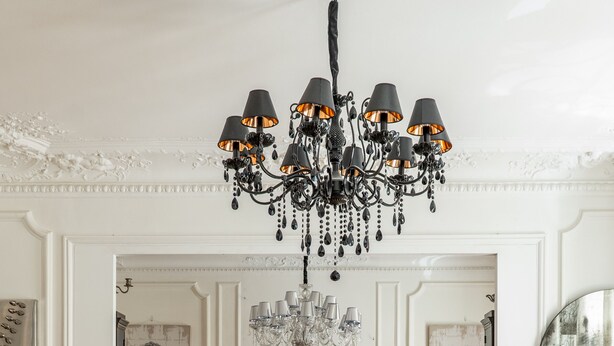 A dining area with a chandelier, wooden chairs, a glass table, and a piano. - Timeless Majesty, by Veeve (Paris)