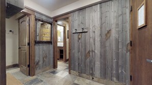 A hallway with wooden doors and a tiled floor. - Upscale 2-bedroom Residence in Resort-style Setting With Saline Outdoor Pool, 2 hot Tubs (Vail)