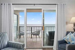 Enjoy ocean views from the balcony with a sofa and outdoor seating area.