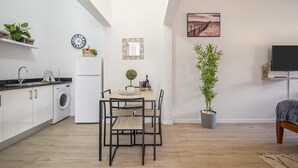 A compact living space with a kitchen, dining area, and a small seating area.