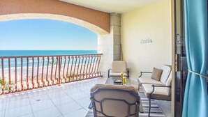 A balcony with a view of the beach and ocean, a table with two chairs, and a sign that reads "Towels". - Outstanding Oceanfront unit with a Breathtaking View - Sonoran Sun E-511 (Puerto Peñasco)